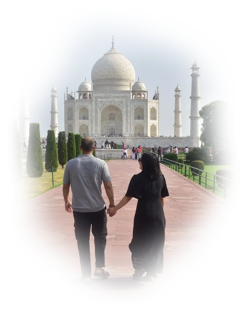 Aabhas and Marianne walking hand in hand toward the Taj Mahal in India